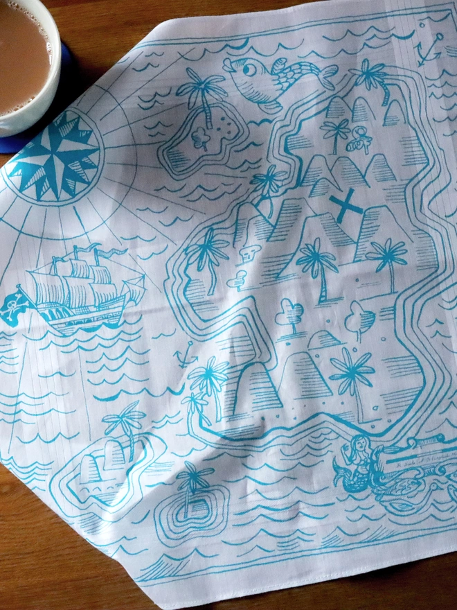 A cotton hankie screenprinted with an illustrated treasure map in aqua