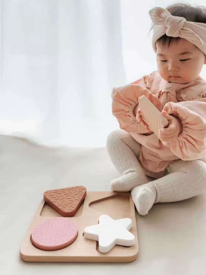 Teether Shape Puzzle in desert, sand, blush and white.