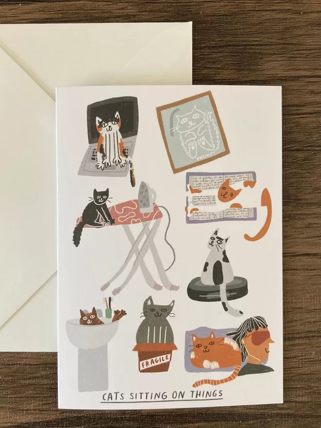 Cat sitting on things card by skeletondraw