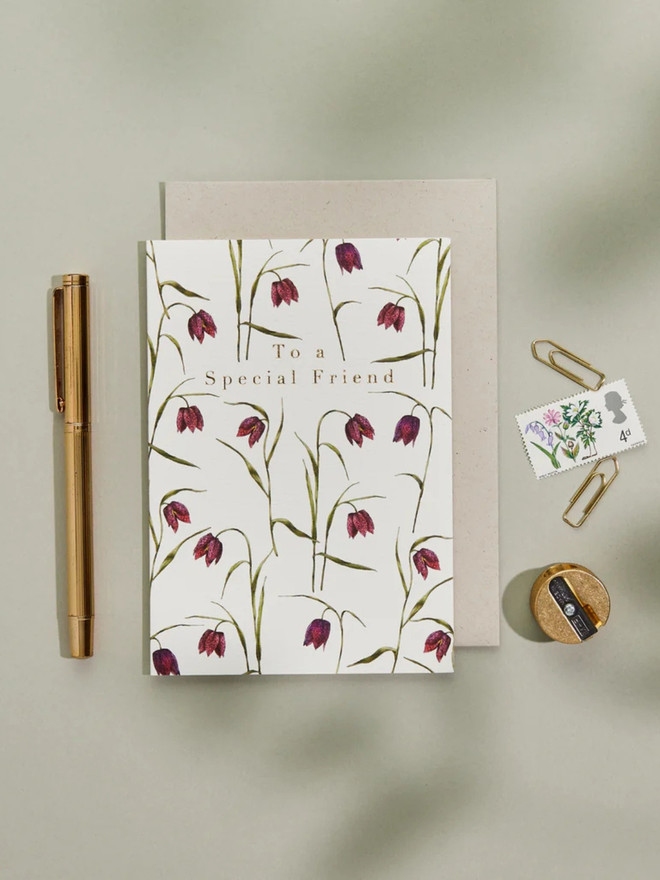 'to a special friend' illustrated floral card. a white floral card photographed against a plain background.