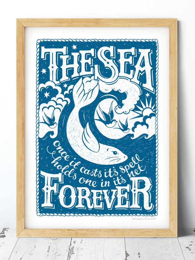 blue and white sea quote print with a seal catching a wave