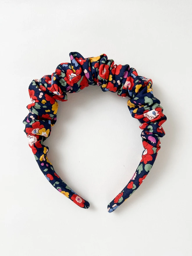 Flatlay photo of alice band hairband for girls in liberty blue floral fabric