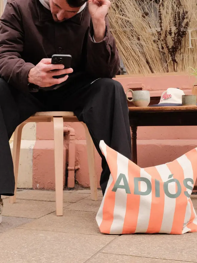 'Hola/Adios' Stripe Tote Bag, against a white background. 