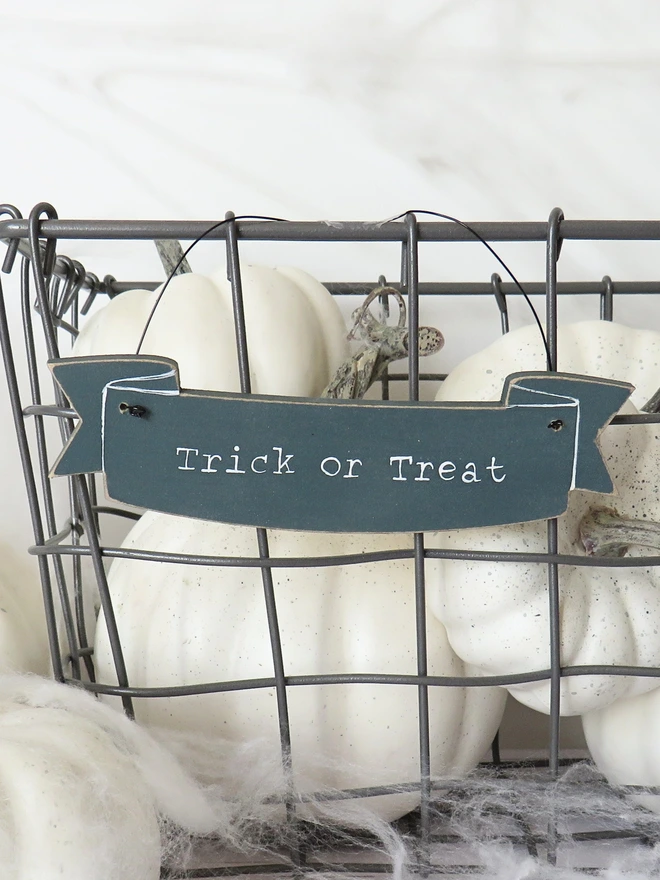 inky blue hand painted wooden banner decoration with trick or treat message