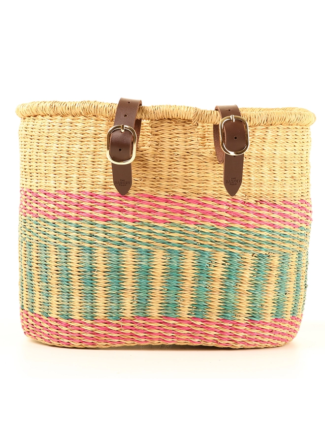 pink and blue woven bike basket with leather straps