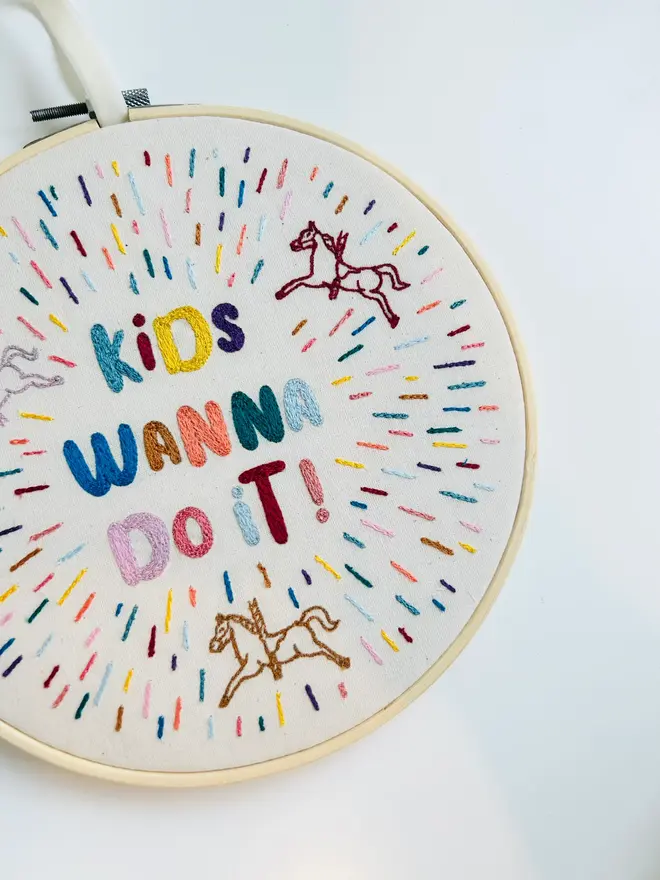 custom embroidered hoop. cotton hoop embroidered with multi coloured lettering.