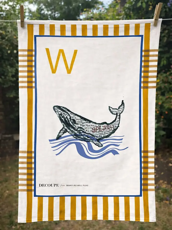 a-z alphabet tea towel. a tea towel with a whale print and the letter 'w' in the corner.