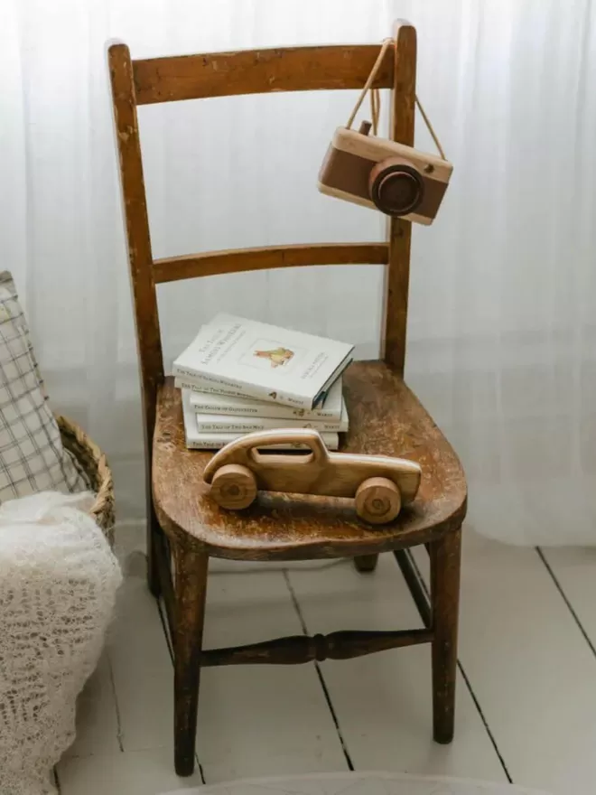 high angle of the wooden toy car with a stack of books behind it