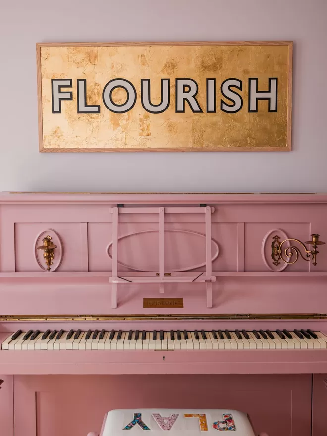 Modo sign Flourish seen above a piano