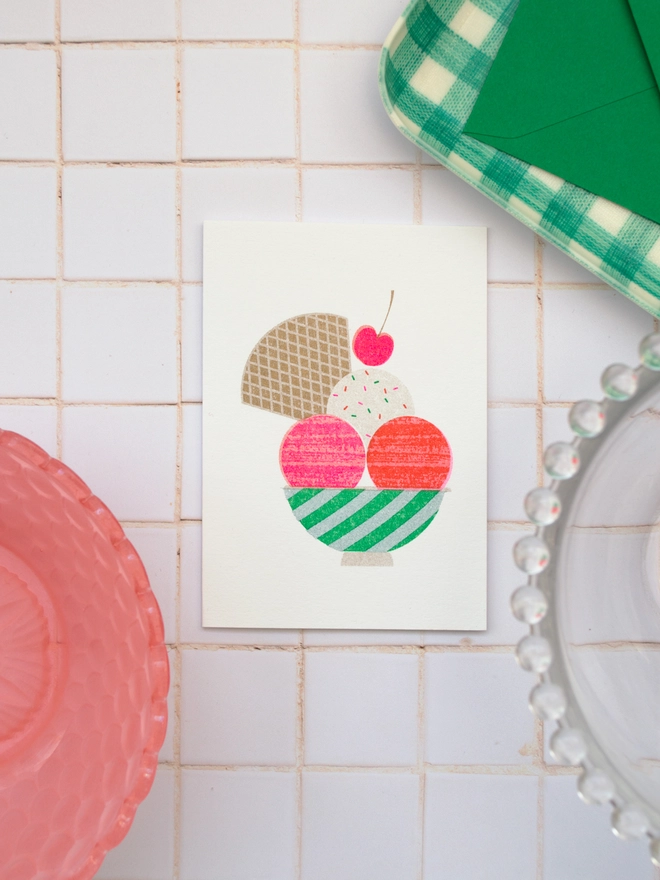 A retro feeling ice cream sundae risograph printed mini greeting card. This delectable little cream is filled with all good things, crunch wafer, cool ice cream, sprinkles and of course a cherry on top! The perfect little card for joyful birthday celebrations, lively party invitations or just the perfect card for the foodie in your life.