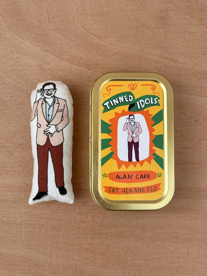 Mini fabric doll of Alan Carr and tin 
