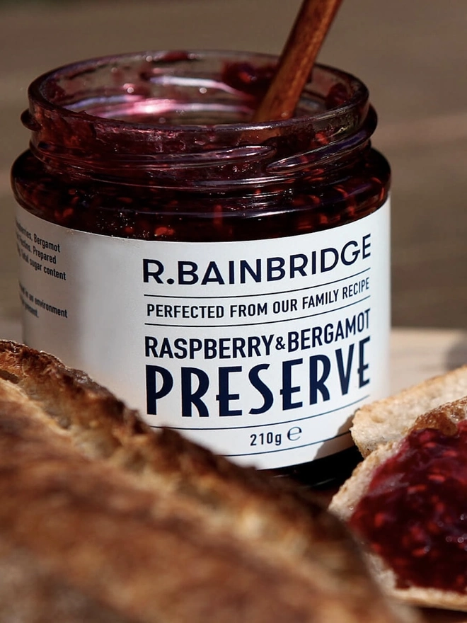 Raspberry & Bergamot Jam (Set Of 1, 2 Or 3), a jar of jam sitting next to some food. 