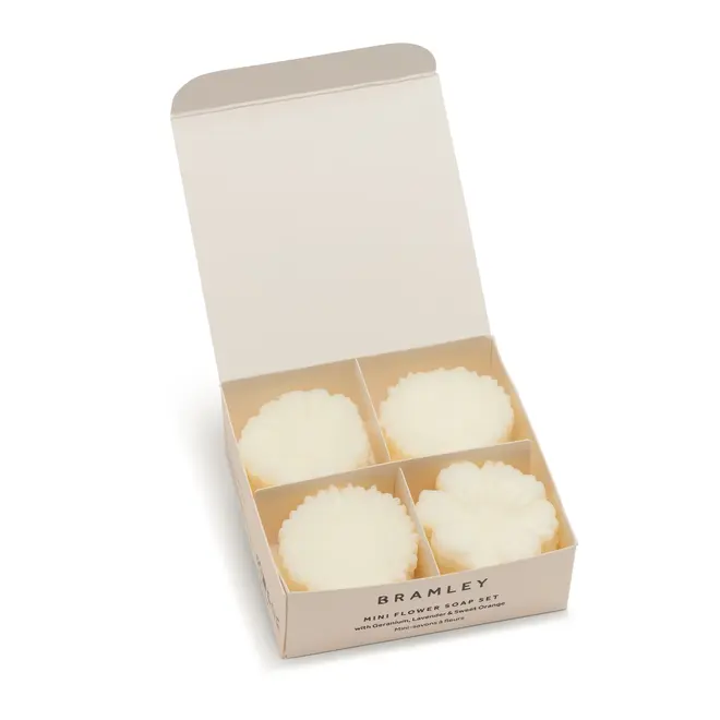 white box, open to show 4 stacks of 3 white flower shaped soaps