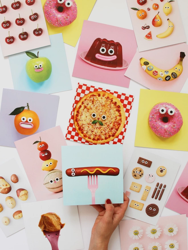 A selection of colourful cards all foods with faces. 