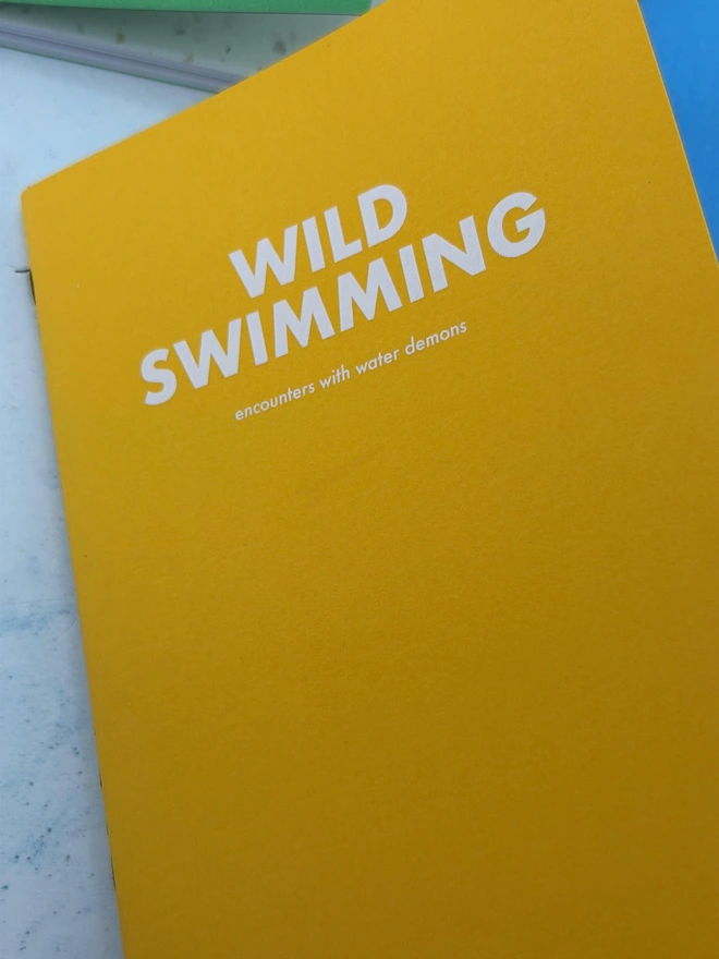 a personalised notebook that says wild swimming, encounters with water demons