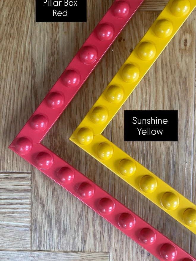 Colour swatches of bobbin mirrors in pillar box red and sunshine yellow