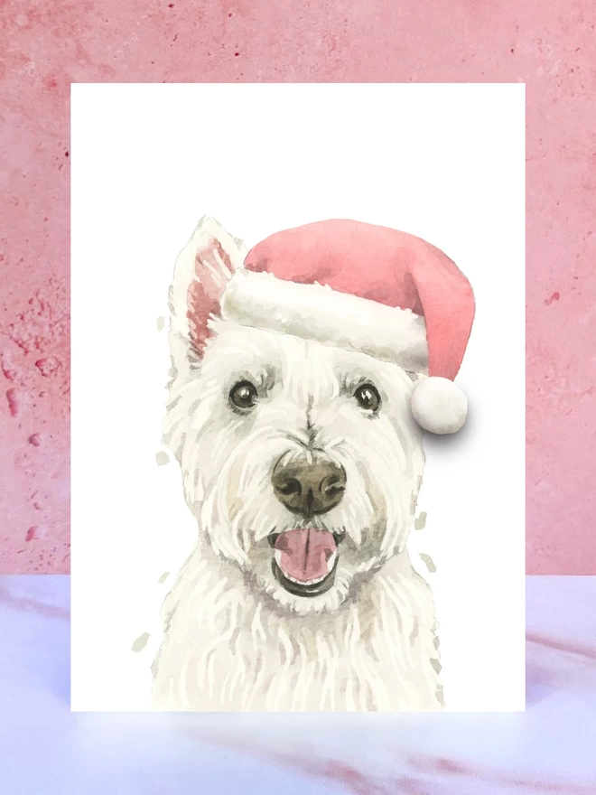 A Christmas card featuring a hand painted design of a west highland terrier, stood upright on a marble surface. 