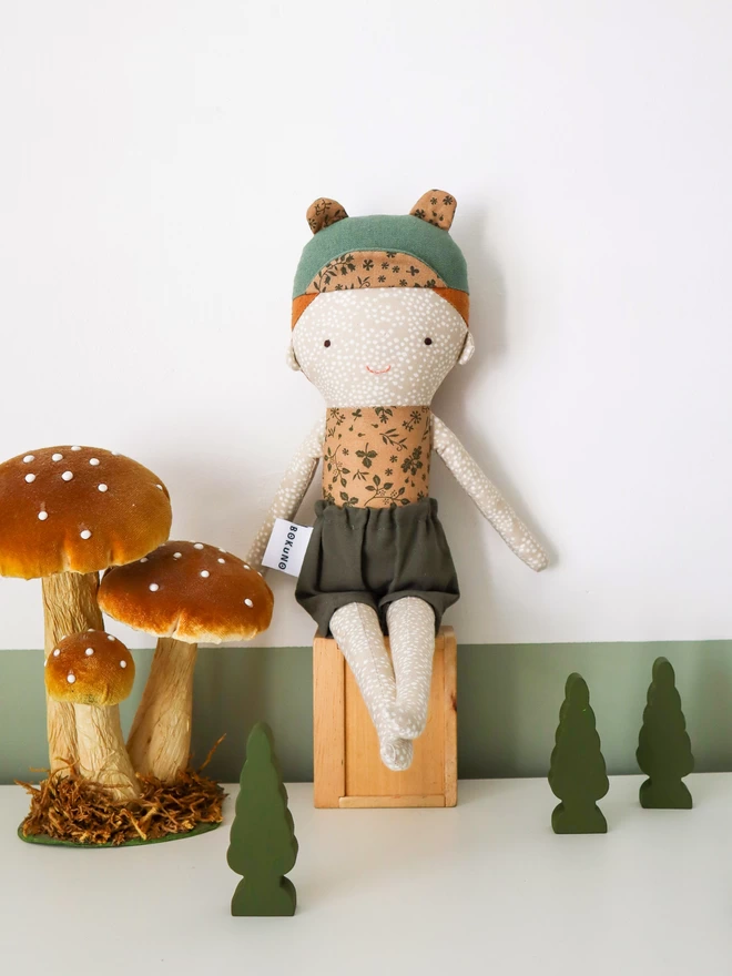 freckled ginger boy doll with green cap with bear ears
