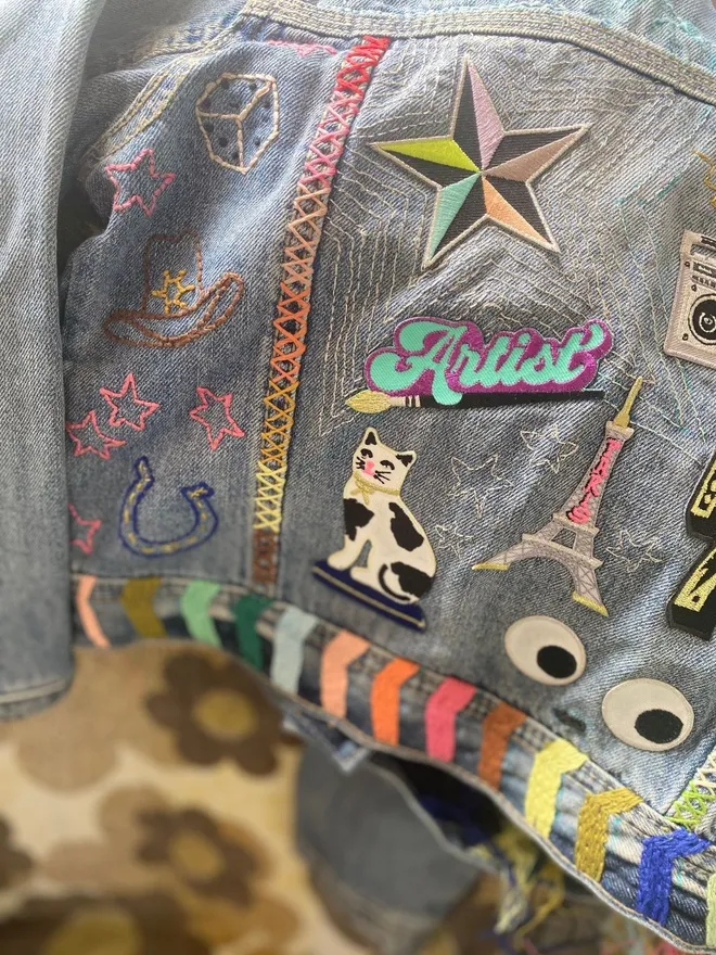 Denim jacket customised with iron on patches and embroidery 