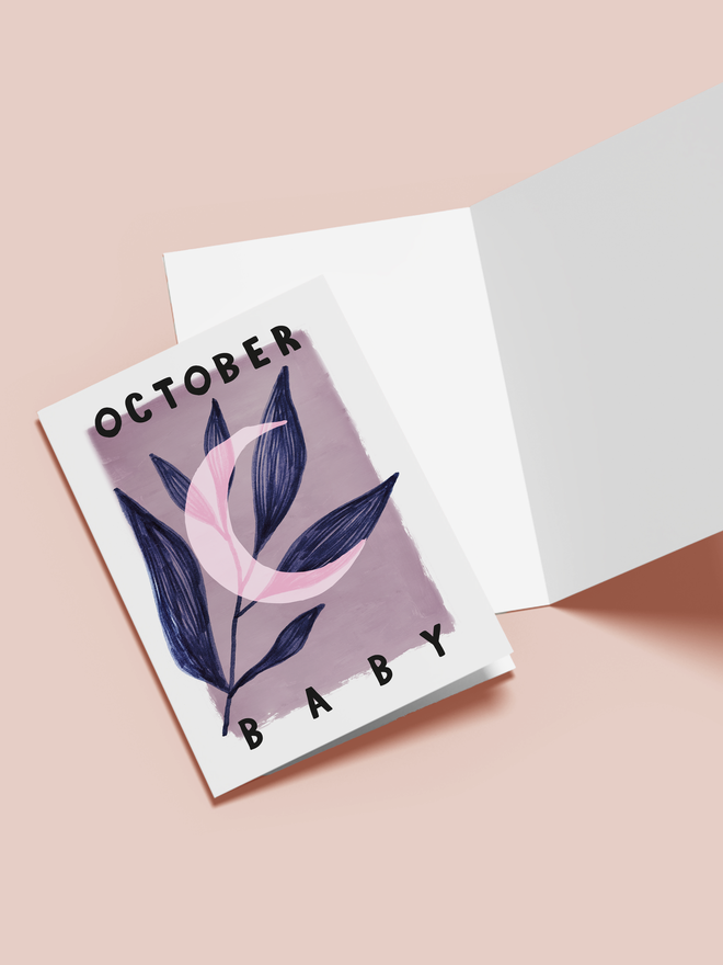 october baby illustrated card. a purple card with a moon and leaves.