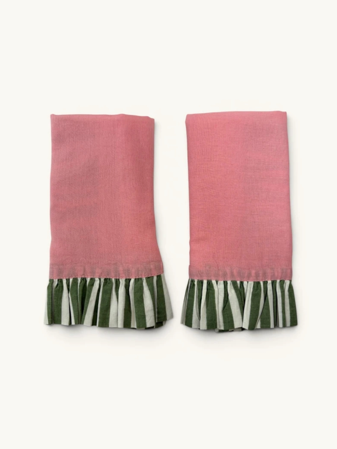 Pair of Ruffle Napkins. A pair of napkins, folded, in powder pink and sage.