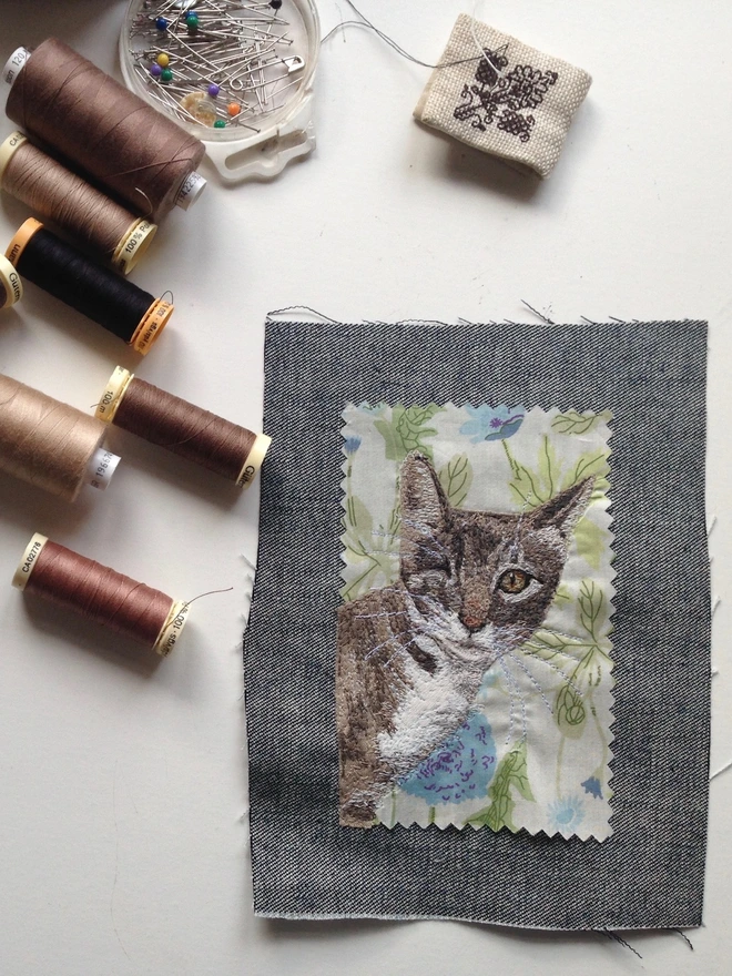 photo shows small embroidered pet portrait on my sewing table