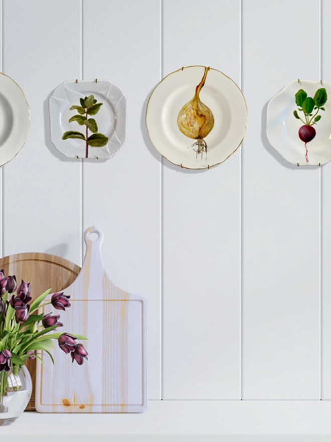 white room with plates on wall