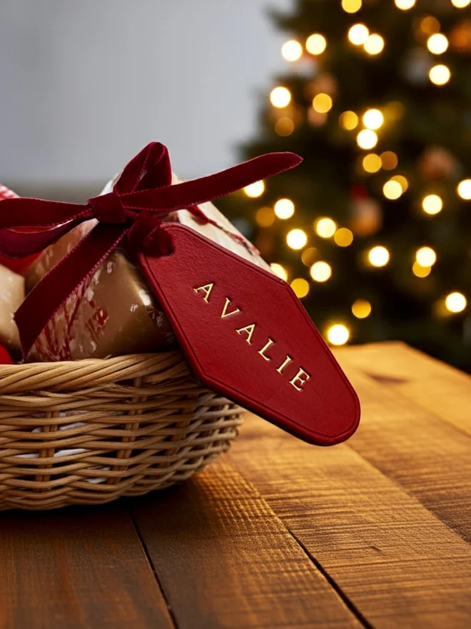 Red leather Christmas eve box label with the name Avalie written in gold