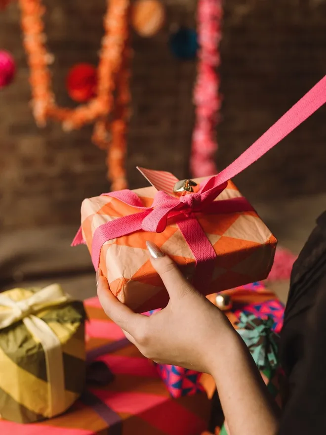 Tissue paper wrapped gift and pink ribbon
