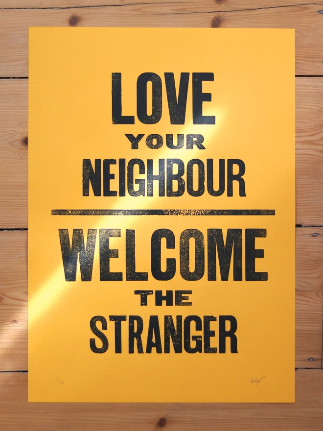 Original letterpress poster featuring the words 'love your neighbour, welcome the stranger'