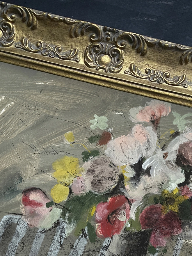 a print of a painterly floral bouquet with a sketchy feel and stripy tablecloth in an ornate gold frame