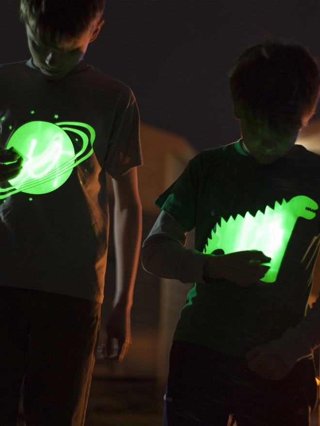 Solar and dinosaur glow up tshirts in the night
