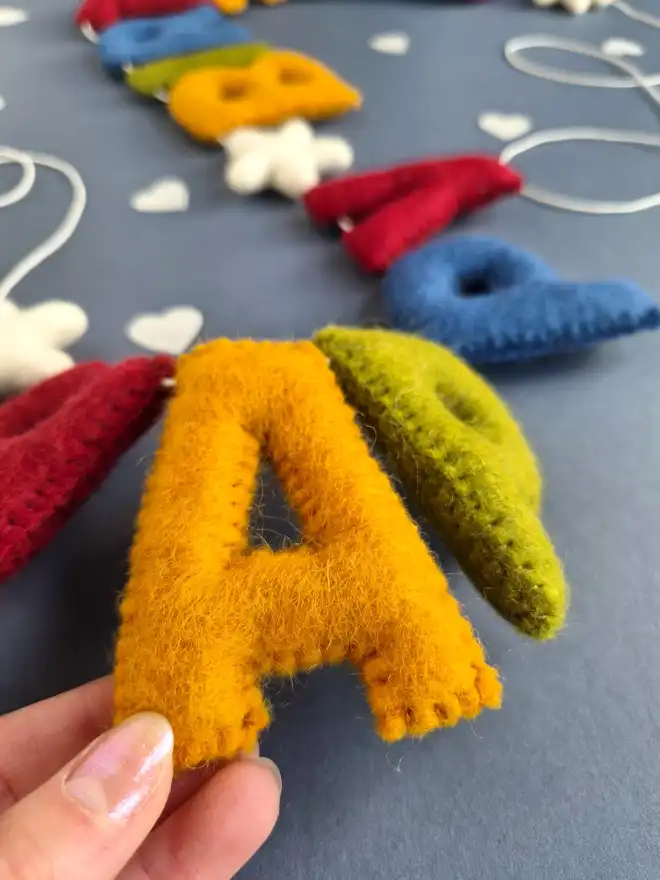 Felt hand stitched letters featuring the word 'Happy Birthday' in gorgeous rich tones