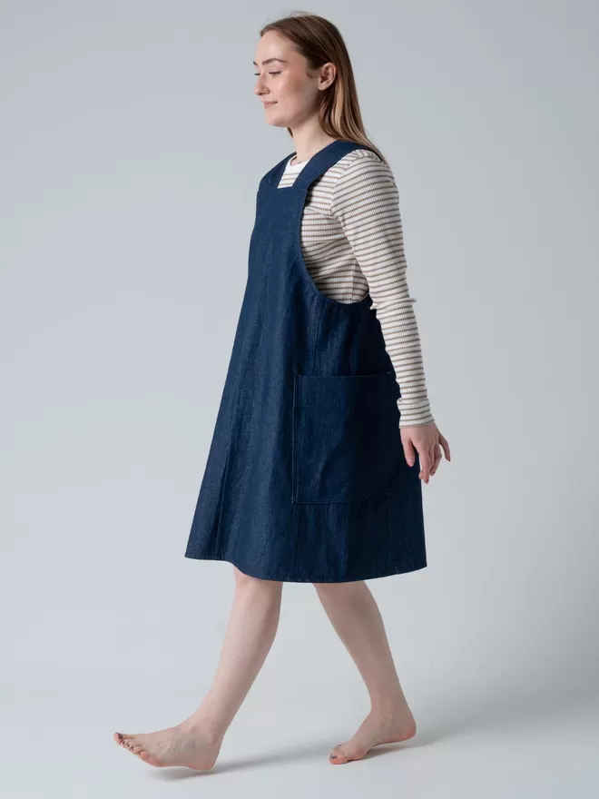 Trapeze line denim pinafore dress. Knee length with 2 large patch pockets.