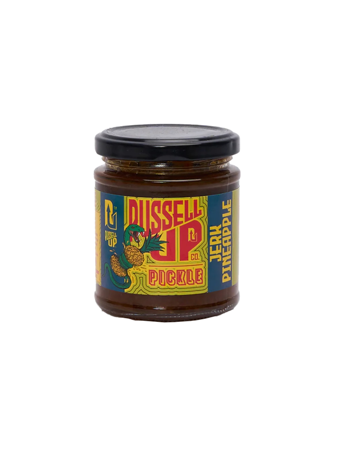pineapple jerk relish. a jar of pineapple relish photographed against a white background, featuring a snake wrapped around a pineapple on the label.