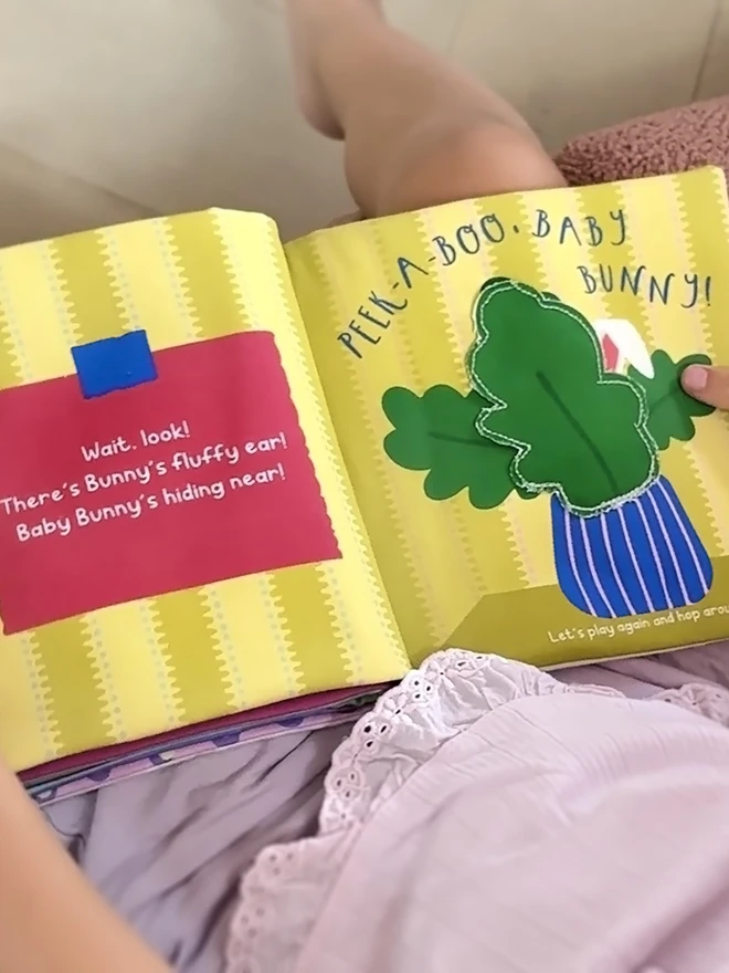 Little hands holding Where's Baby Bunny? Lift-the-flap Cotton Soft Book