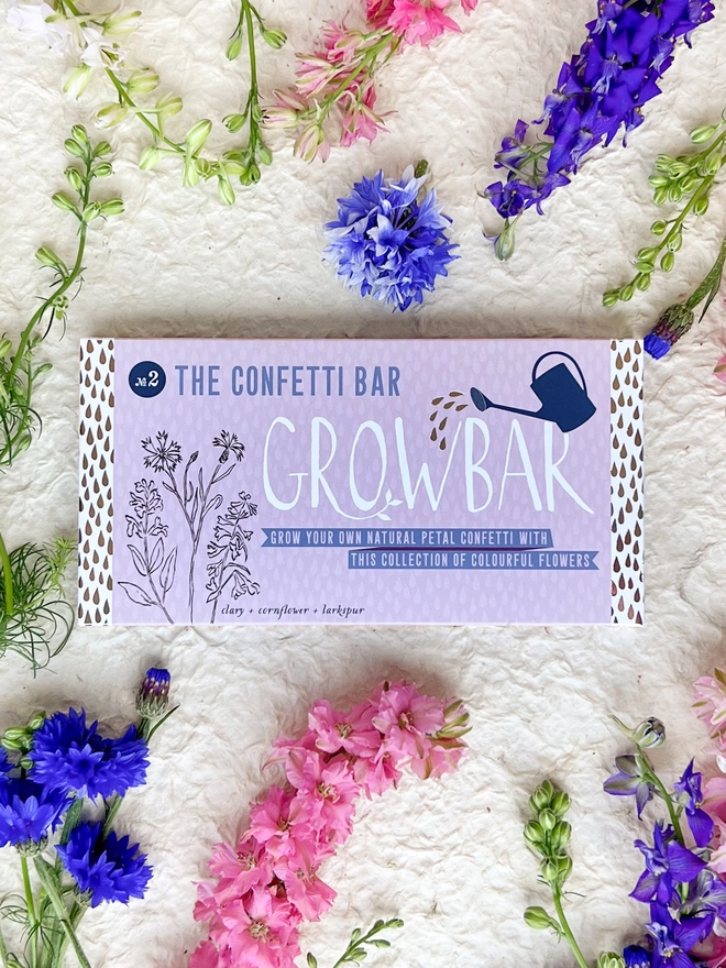 The  Confetti Growbar on a bed of bright blue cornflowers, pink larkspur and delicate buds of clary.