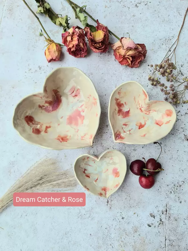 ceramic heart nesting bowls , valentines gift , ceramic bowls, pottery bowls, tableware, homeware, Jenny Hopps Pottery, pink, green, cream, photographed with dried flowers on a grey and speckled background