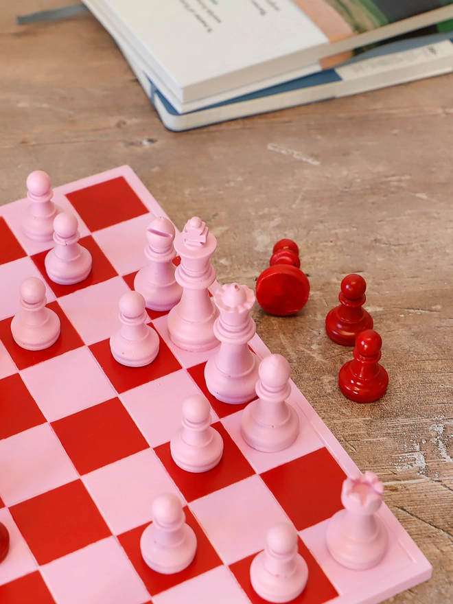 Handmade Jesmonite Chess Board, a handmade colourful chess board sitting on a wooden surface. 