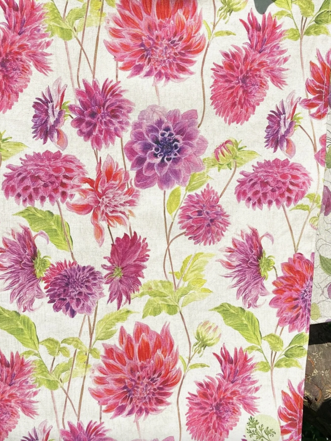 Dahlia Tea Towel. A tea towel patterned with vibrant pink dahlias.