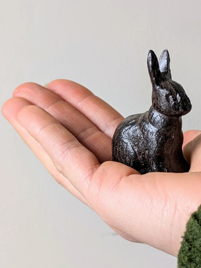 Optional small Cast Iron Bunny decoration in the palm of someones hand