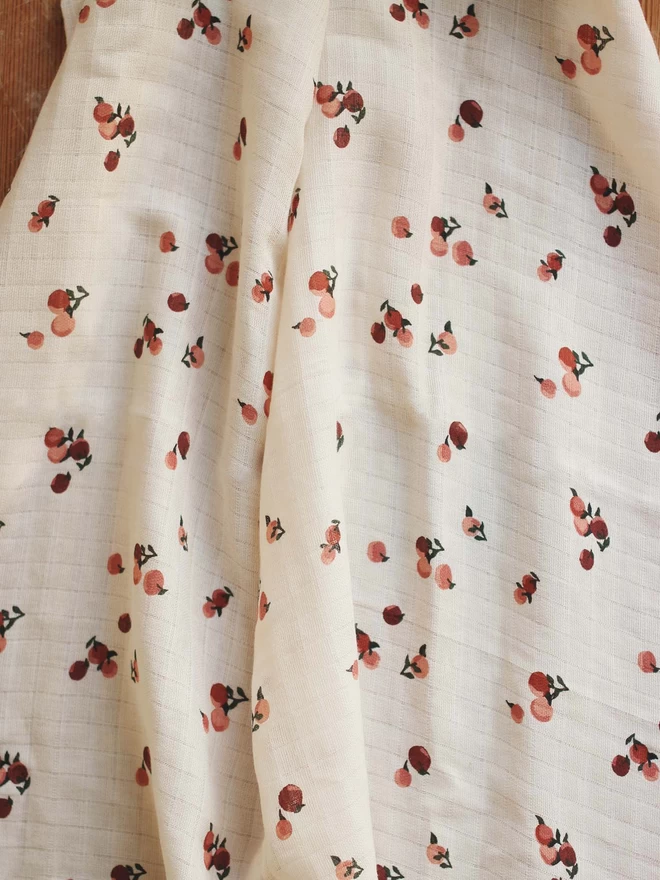 A muslin swaddle in peaches print