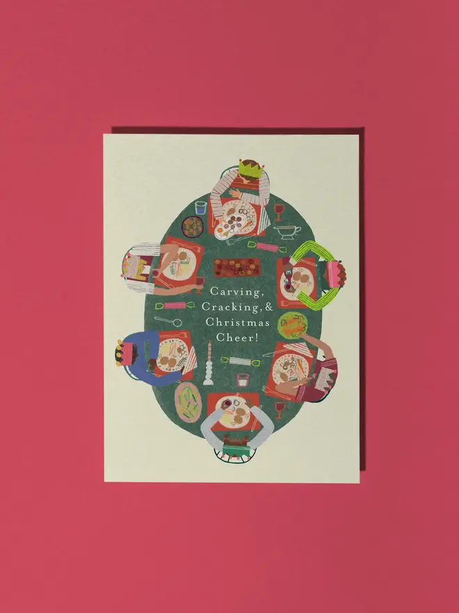 funky festive feast illustrated christmas card. illustration of a festive christmas dinner on a white card, photographed against a red background.