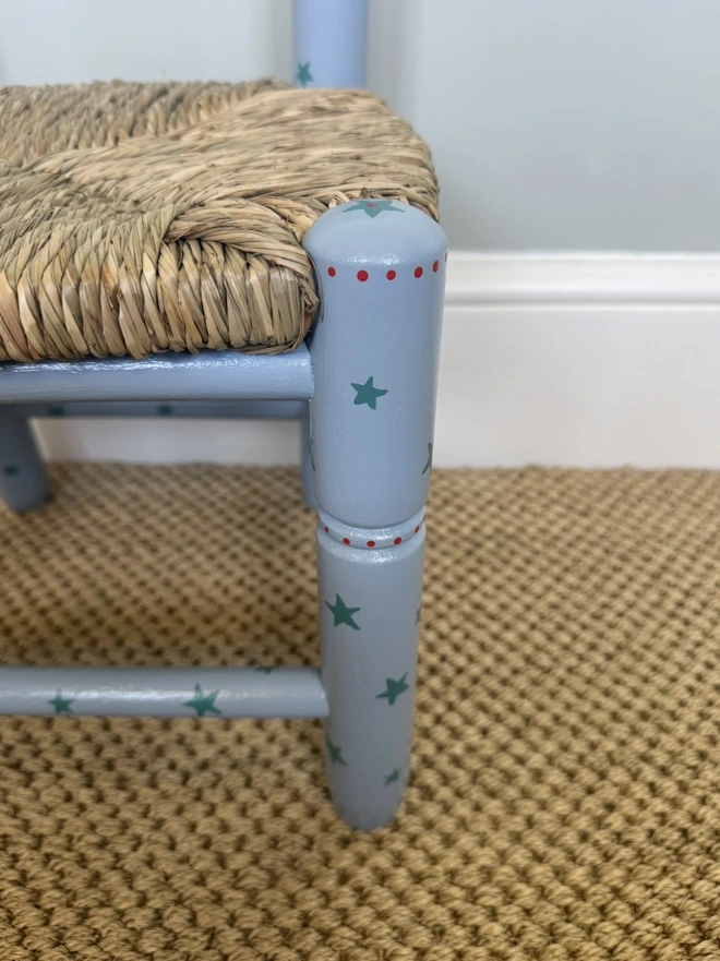 Close up of a blue painted Childs wooden chair. 