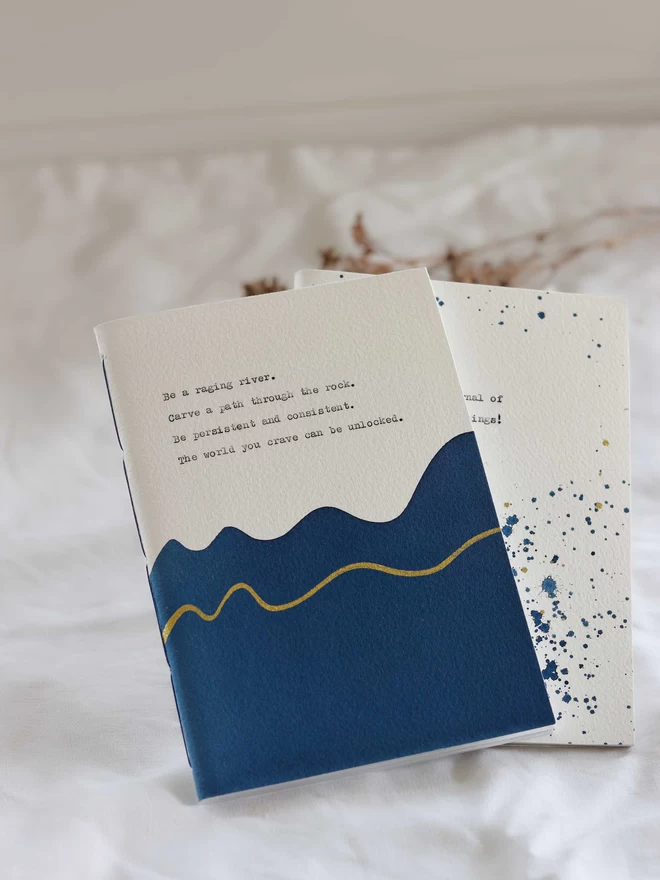 Pair of blue and gold personalised notebooks