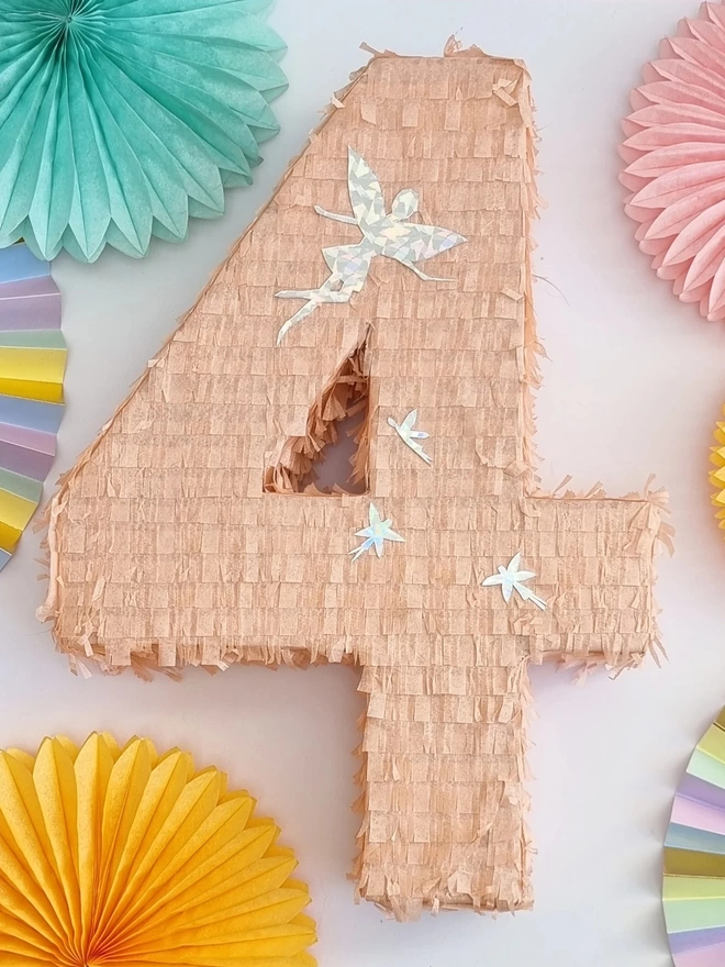 peach colour number 4 pinata with fairy details on a white background surrounded by paper fans