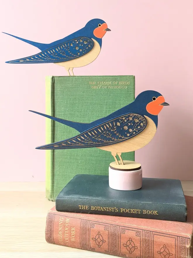 Standing Wooden Barn Swallow, blue wooden bird decoration standing on book. 