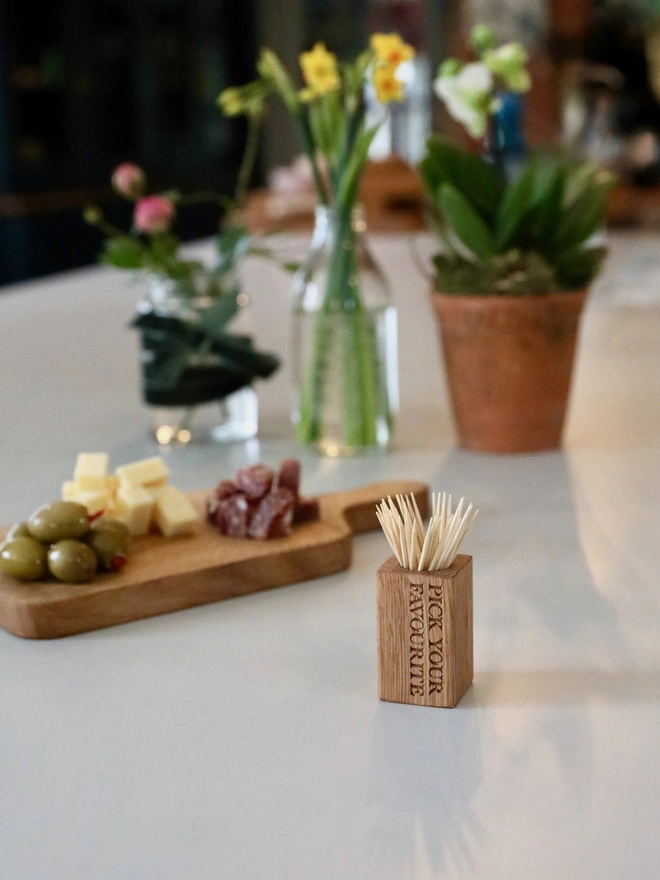 Cocktail Stick Cup with charcuterie in the background