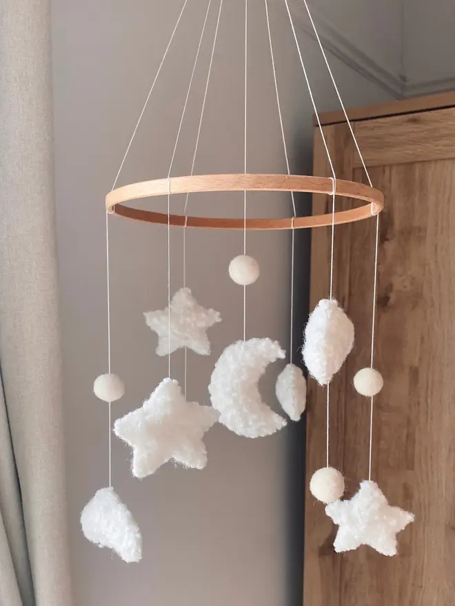 'sweet dreams' boucle baby mobile. a baby mobile hanging from the ceiling with moons, stars and clouds.