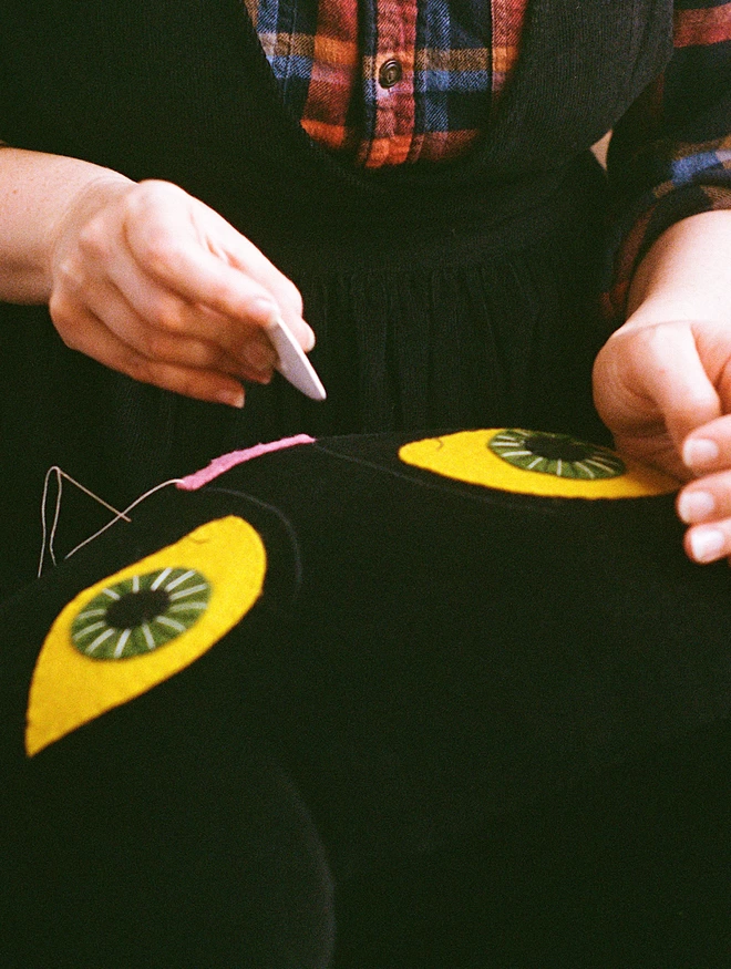 hands marking a cushion with chalk